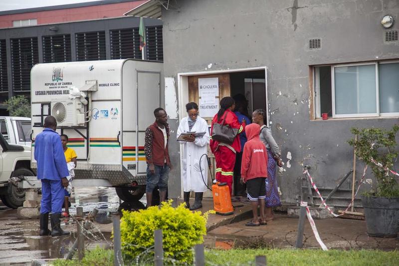 Des travailleurs de la santé et des proches de patients devant un centre de traitement de choléra, dans un hôpital à Lusaka, en Zambie, le 5 janvier 2024. (Xinhua/Martin Mbangweta)